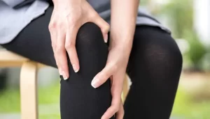 Holding knee from pain