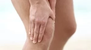 Holding knee in pain from arthritis